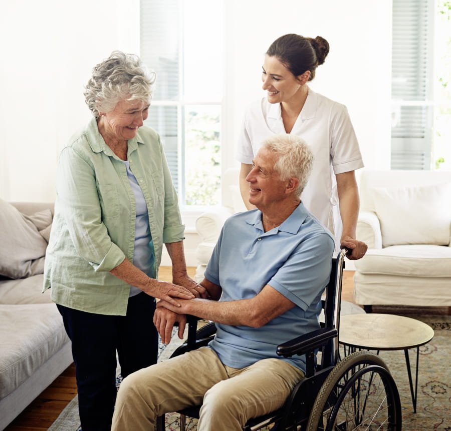 A caregiver and client talking together at home