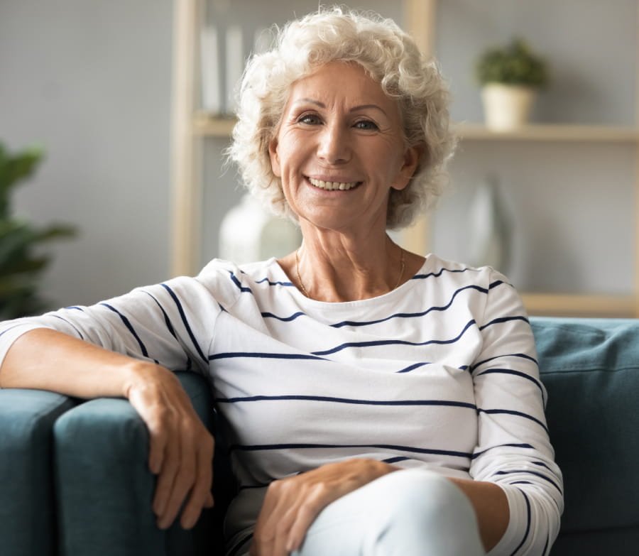 A caregiver supporting a client in the living room