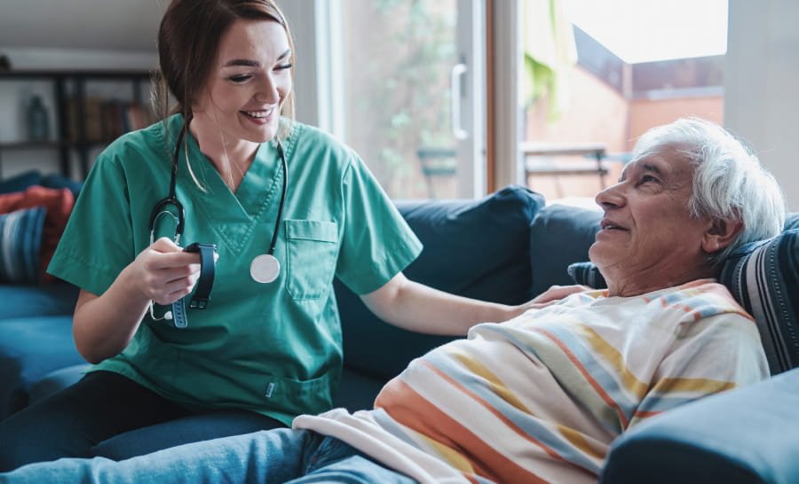 A caregiver and a client walking together outdoors